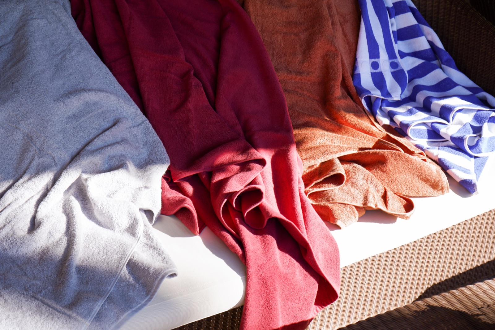 Assortiment de linge de bain coloré installé sur un transat